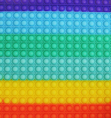 Texture of simple dimple toy. Rainbow Pop it.
