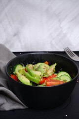Vegetable salad with avocado, tomatoes, cucumbers. Food. Cooking.