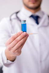 Young male doctor in vaccination concept