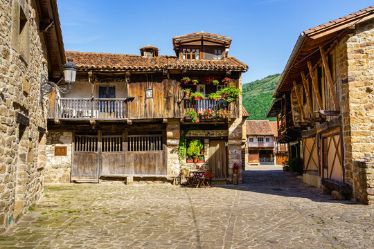 Stone houses and narrow alley in mountain village in northern Spain. Barcena Mayor.