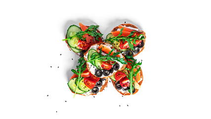 Bruschetta with cream cheese, salmon and vegetables isolated on a white background. Toasts...