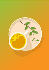 A cup of yellow matcha with foam on a stand with a spring