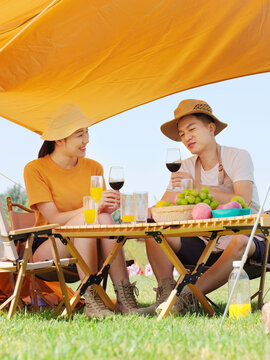 A Young lovers have a picnic outdoors