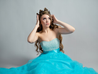 charming princess in a crown. Young beautiful blonde with long wavy hair © Ulia Koltyrina