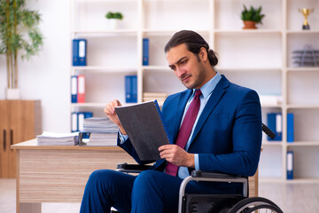 Young disabled employee working in the office