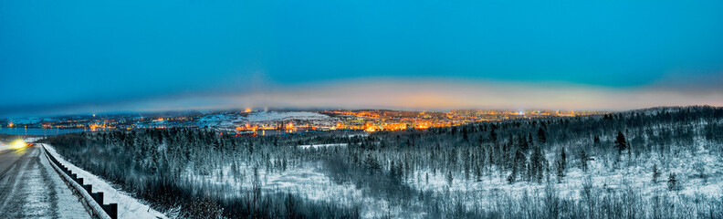 Panorama - the night city of Murmansk, a road along the coast of the Kola Bay.