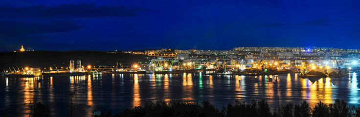 Fototapeta na wymiar Panorama - Night City Murmansk, commercial sea port, Kola Bay.