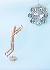 Wooden man praying for money. Wishing the best. Concept.