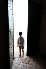 Fototapeta na wymiar child coming out the door - ready for a new challenge to be free Concept.