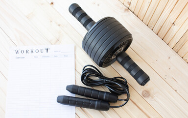 Ab roller, abdominal roller exercises, abdominal strength trainer on a wooden background, close up.