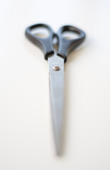 Scissors on white background. Vertical photo. Copy space. Selective focus.