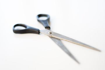 Scissors on white background. Selective focus. Blurred areas. Copy space.