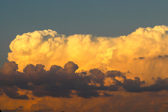 Orange cumulonimbus cloud at sunset 