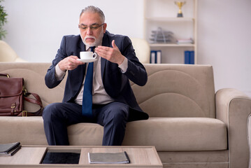 Old businessman employee waiting for business meeting