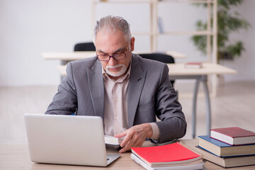 Aged male teacher in the classroom