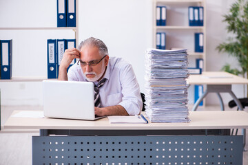 Old male employee unhappy with excessive work in the office