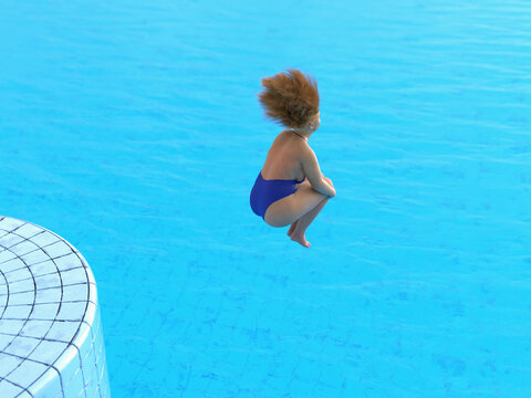 plump woman jumping into the pool