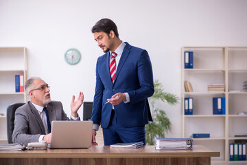 Two male employees working in the office