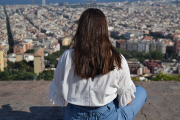 Persona mujer joven mirando al horizonte en Barcelona con la ciudad de fondo