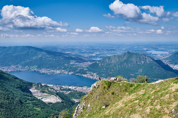 Men walking on mountain peak with beautiful panorama in background