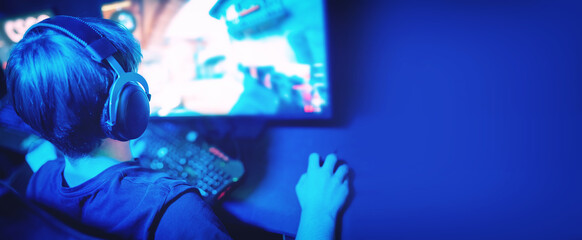 Young man esports playing online shooter with machine guns, professional cyber game training, neon color banner