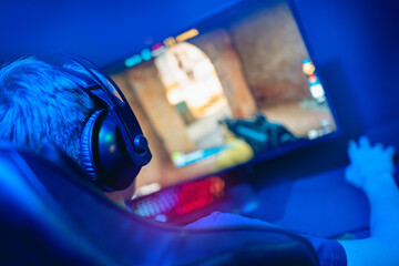 Soft focus, Professional cyber gamer play in video game championship in neon color blur background