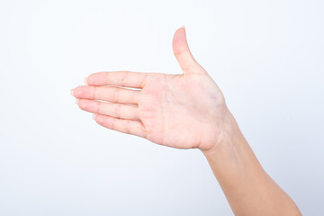 hand holding something on the palm, hand isolated over white background greeting someone saying hello with thumb up. Hand pointing aside