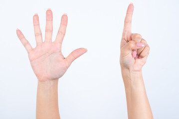 hands with pink manicure over white background pointing up with fingers number six. 