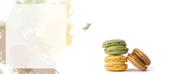 Delicious colorful macarons on green, yellow and brown watercolor background, closeup, Space for text with white frame
