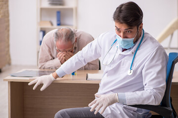 Old male patient visiting young male doctor during pandemic in f