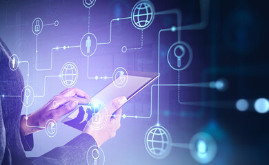 Businesswoman hands is holding tablet device and touching screen by finger. Digital interface with social media and data security icons on background. Concept of networking and cooperation