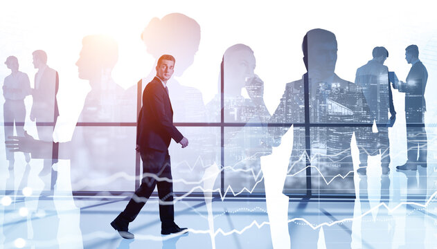 Businessman walking along panoramic office. Diverse business peo