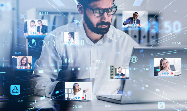 Handsome beard businessman in glasses using laptop to be a part of video conference call, business colleagues, a team communicating on the distance, hologram digital interface