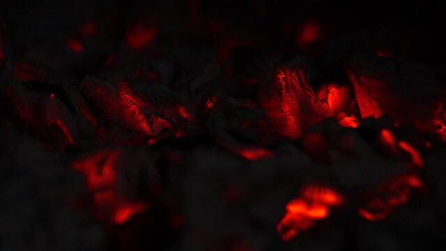 Smoldering embers .The burning texture of red charcoal in a barbecue grill.