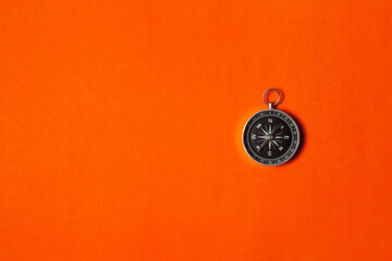 Compass on orange background. Concept signs symbols.