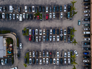 Beautiful cinematic aerial zenith view of a shopping mall parking lot full of cars © Gian