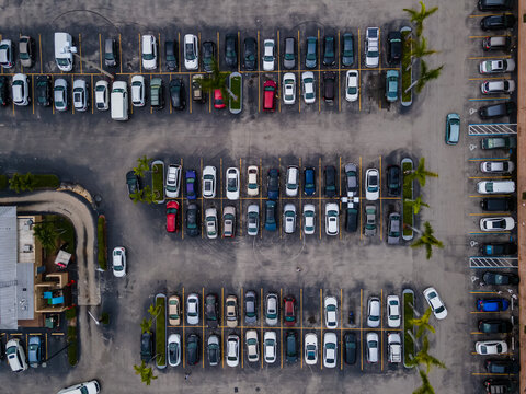  Beautiful cinematic aerial zenith view of a shopping mall parking lot full of cars