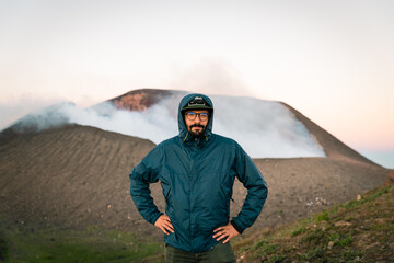 Young traveler on an active volcano at sunrise. © PGS