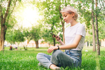Obraz premium girl is talking on the phone, writing SMS and surfing the Internet. 