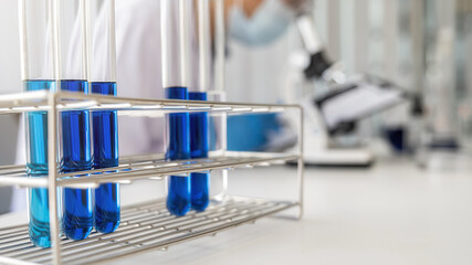 Scientist working with microscope for vaccine development in pharmaceutical research laboratory. Innovation Concept.