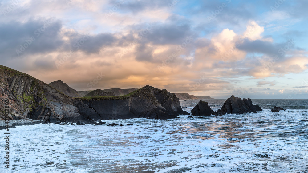 Wall mural stunning landscape image of view from hartland quay in devon england durinbg moody spring sunset