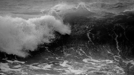 Beautiful dark dramatic toned fine art seascape image of breaking waves on Atlantic Ocean in Devon England