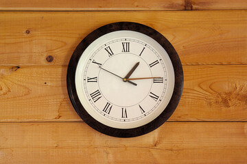 round white clock on a wooden wall