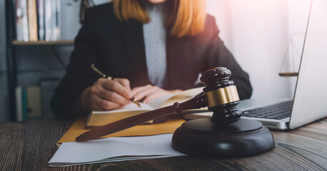 Business and lawyers discussing contract papers with brass scale on desk in office. Law, legal services, advice, justice and law concept picture with film grain effect
