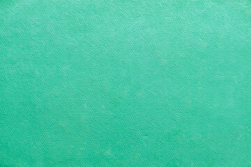 a light green textured background of an old book