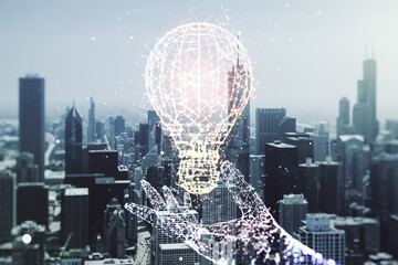Double exposure of creative light bulb hologram on Chicago city skyscrapers background, research...