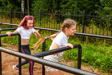 Fototapeta na wymiar Funny girls running through the sports labyrinth. Warm-up, children, exercise, exercise lesson, daytime, open air