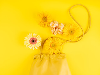 Yellow fashion lady shoulder bag with gerbera daisy flowers on monochrome background