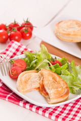 Puff pastry filled with tomato and mozzarella cheese.