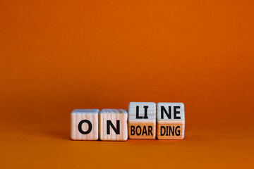 Online onboarding symbol. Turned wooden cubes with words 'online onboarding'. Beautiful orange...